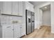 Kitchen features stainless steel refrigerator, white cabinets, quartz countertops, and subway tile backsplash at 3888 Grand Baker St, Aurora, CO 80019