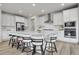 Modern kitchen with white cabinets, a large island with seating, and stainless steel appliances at 3888 Grand Baker St, Aurora, CO 80019