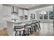 Bright kitchen featuring a large island with seating, modern appliances, and stylish white cabinetry at 3888 Grand Baker St, Aurora, CO 80019