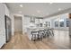 Bright kitchen with a large island, bar stools, and an open layout to the dining area at 3888 Grand Baker St, Aurora, CO 80019