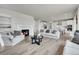 Spacious living room flows into an open kitchen, featuring a fireplace, modern furnishings, and hardwood floors at 3888 Grand Baker St, Aurora, CO 80019