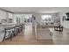 Bright living room featuring hardwood floors, a kitchen bar, and comfortable seating at 3888 Grand Baker St, Aurora, CO 80019