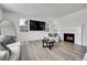 Inviting living room features a fireplace, large mirror, and stylish decor for cozy gatherings at 3888 Grand Baker St, Aurora, CO 80019