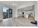 Open concept living space featuring dining area flowing into kitchen with bar stool seating and Gathering room at 3888 Grand Baker St, Aurora, CO 80019