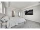 Spacious main bedroom featuring soft carpet, ceiling detail, and large television for relaxing at 3888 Grand Baker St, Aurora, CO 80019