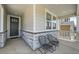 Inviting front porch with stone accents, two chairs, and a view of the home's exterior at 3888 Grand Baker St, Aurora, CO 80019
