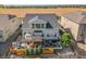Aerial view of the backyard featuring a pergola, fire pit, play house, and mature landscaping at 14066 Ivanhoe Ct, Thornton, CO 80602