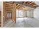 Unfinished basement with concrete floor and exposed wood framing, offering potential for customization at 14066 Ivanhoe Ct, Thornton, CO 80602
