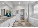 Modern bathroom features double sinks, granite counters, and a separate shower and soaking tub at 14066 Ivanhoe Ct, Thornton, CO 80602