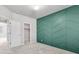 Bedroom boasts green accent wall, carpet floors, and includes a walk-in closet at 14066 Ivanhoe Ct, Thornton, CO 80602