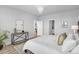 Charming bedroom showcasing chandelier lighting, art and views into the Primary bathroom at 14066 Ivanhoe Ct, Thornton, CO 80602
