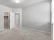 Bright bedroom featuring closet, white walls, and plush carpet flooring at 14066 Ivanhoe Ct, Thornton, CO 80602