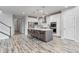 Bright, open kitchen featuring a large island, stainless steel appliances, and seamless access to other living areas at 14066 Ivanhoe Ct, Thornton, CO 80602