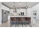 Modern kitchen with stainless steel appliances, island with seating, and stylish pendant lighting at 14066 Ivanhoe Ct, Thornton, CO 80602