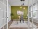 Bright office featuring a glass desk, modern lighting, and neutral decor, creating a productive workspace at 14066 Ivanhoe Ct, Thornton, CO 80602