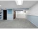 This carpeted basement features built-in shelving and a blue accent wall at 7217 S Zephyr Way, Littleton, CO 80128