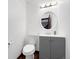 Bathroom features wood floors, a toilet and a gray vanity at 7217 S Zephyr Way, Littleton, CO 80128