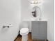 Bathroom features wood floors, a toilet and a gray vanity at 7217 S Zephyr Way, Littleton, CO 80128