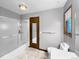 Bathroom with combination tub/shower, mirrored medicine cabinet, and neutral color palette at 7217 S Zephyr Way, Littleton, CO 80128