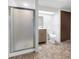 This bathroom features a glass enclosed shower and neutral vanity at 7217 S Zephyr Way, Littleton, CO 80128
