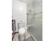 Bathroom featuring a toilet, shower, and a frosted glass door at 7217 S Zephyr Way, Littleton, CO 80128