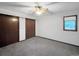 Bedroom featuring neutral carpet, double closets, and natural lighting at 7217 S Zephyr Way, Littleton, CO 80128