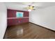 A primary bedroom with wood floors, ceiling fan, and natural light at 7217 S Zephyr Way, Littleton, CO 80128