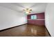 A primary bedroom with wood floors, ceiling fan, and natural light at 7217 S Zephyr Way, Littleton, CO 80128