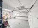 A garage with a work bench, built-in shelving and a roll up door at 7217 S Zephyr Way, Littleton, CO 80128