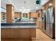 Kitchen view featuring wooden cabinetry, stainless steel appliances, and a gray granite island at 7217 S Zephyr Way, Littleton, CO 80128