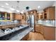 View of a kitchen with wooden cabinetry, granite counter tops, and stainless appliances at 7217 S Zephyr Way, Littleton, CO 80128