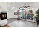Bright living room with tile flooring, a modern fireplace, and large windows overlooking the backyard and garden at 7217 S Zephyr Way, Littleton, CO 80128