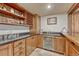 This bar area boasts custom wood cabinets, a wine rack, counter seating, and under-cabinet refrigerator at 5275 Pinyon Jay Rd, Parker, CO 80134