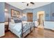 Comfortable bedroom with wrought iron bed frame, wood accents, and ensuite bathroom access at 5275 Pinyon Jay Rd, Parker, CO 80134