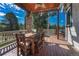 Inviting covered deck showcases a dining area, perfect for outdoor meals and entertaining with wooded views at 5275 Pinyon Jay Rd, Parker, CO 80134