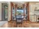 Inviting dining room with hardwood floors, large windows overlooking the yard, and decorative lighting at 5275 Pinyon Jay Rd, Parker, CO 80134