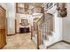 Grand foyer with a curved staircase, chandelier, and elegant tile flooring at 5275 Pinyon Jay Rd, Parker, CO 80134