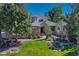 Charming stone and stucco home with lush landscaping, mature trees, and inviting water feature at 5275 Pinyon Jay Rd, Parker, CO 80134