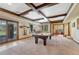 Bright game room features a pool table, recessed lighting, and walk-out access to the backyard at 5275 Pinyon Jay Rd, Parker, CO 80134