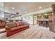 Stylish home theater featuring a large projector screen, a bar area, and comfortable leather seating at 5275 Pinyon Jay Rd, Parker, CO 80134