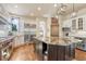 Bright kitchen featuring a large island, stainless steel appliances, and hardwood floors at 5275 Pinyon Jay Rd, Parker, CO 80134
