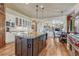 Open kitchen layout with island, stainless steel appliances, and views into the living area at 5275 Pinyon Jay Rd, Parker, CO 80134