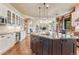 Modern kitchen with island seating, and views to the living room at 5275 Pinyon Jay Rd, Parker, CO 80134