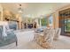 Spacious living room features a stone fireplace, built-in shelving, plush seating, and large windows at 5275 Pinyon Jay Rd, Parker, CO 80134