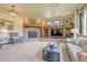Bright and airy living room with stone fireplace, built-in shelving, and comfortable seating at 5275 Pinyon Jay Rd, Parker, CO 80134