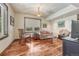 Cozy living room features hardwood floors, large windows, and a mix of stylish seating arrangements at 5275 Pinyon Jay Rd, Parker, CO 80134