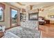 Elegant main bedroom featuring a fireplace, a cozy seating area, and balcony access at 5275 Pinyon Jay Rd, Parker, CO 80134