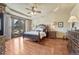 Spacious main bedroom featuring a tray ceiling, balcony access, and a cozy seating area at 5275 Pinyon Jay Rd, Parker, CO 80134