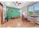 Bright home office with wooden desk, green accent wall, and large window offering serene views at 5275 Pinyon Jay Rd, Parker, CO 80134