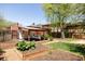 Landscaped backyard with garden plots, a patio, and a covered outdoor area at 650 Kearney St, Denver, CO 80220